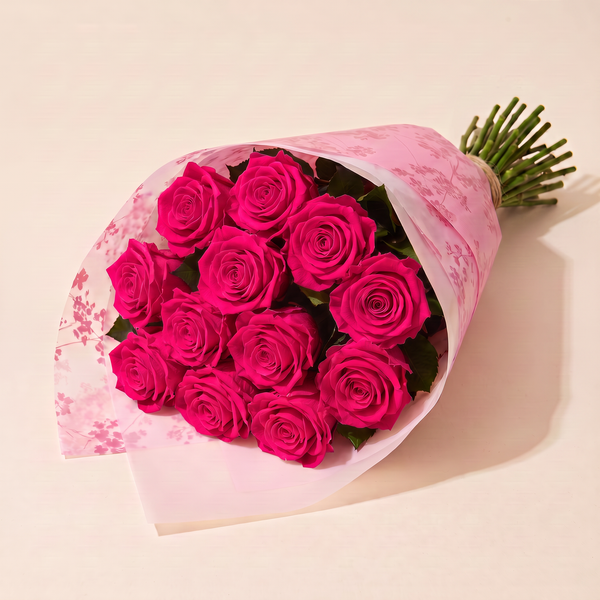Dozen preserved roses in pink floral wrap - Fuchsia