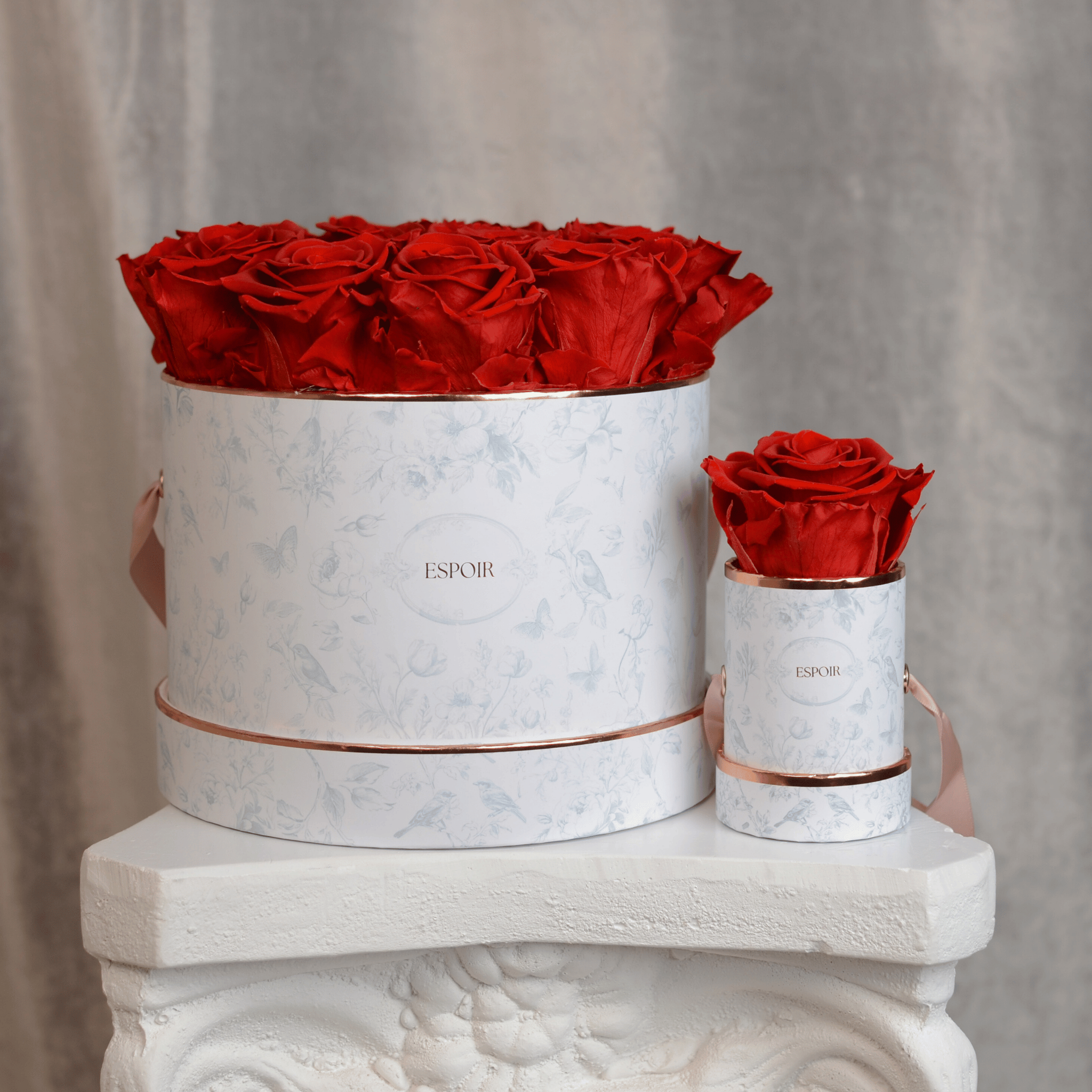 Blue Toile Collection featuring preserved rose boxes and hatbox arrangements with rose gold accents
