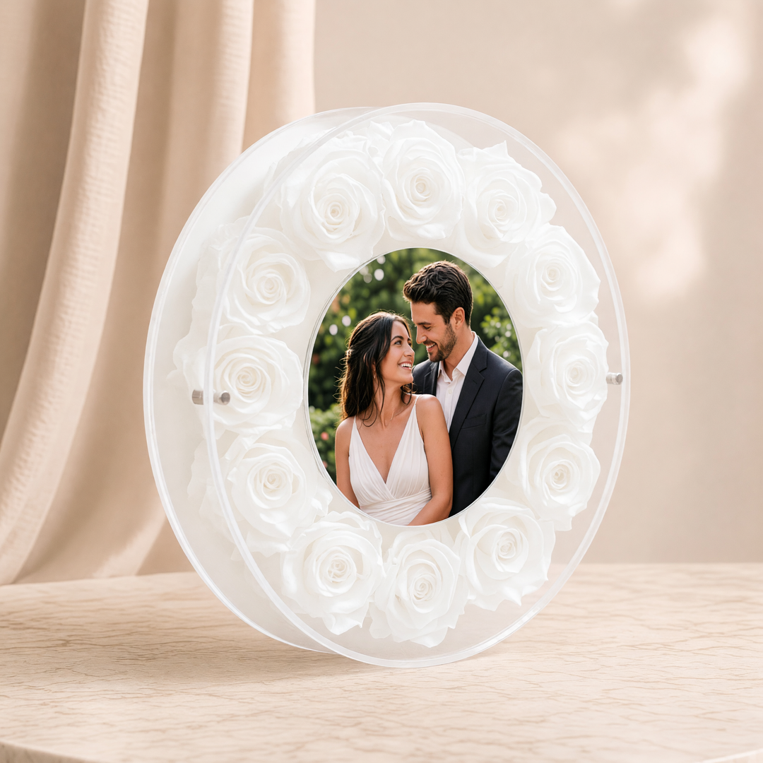 Large 10-inch round acrylic photo frame with white preserved roses, angled view