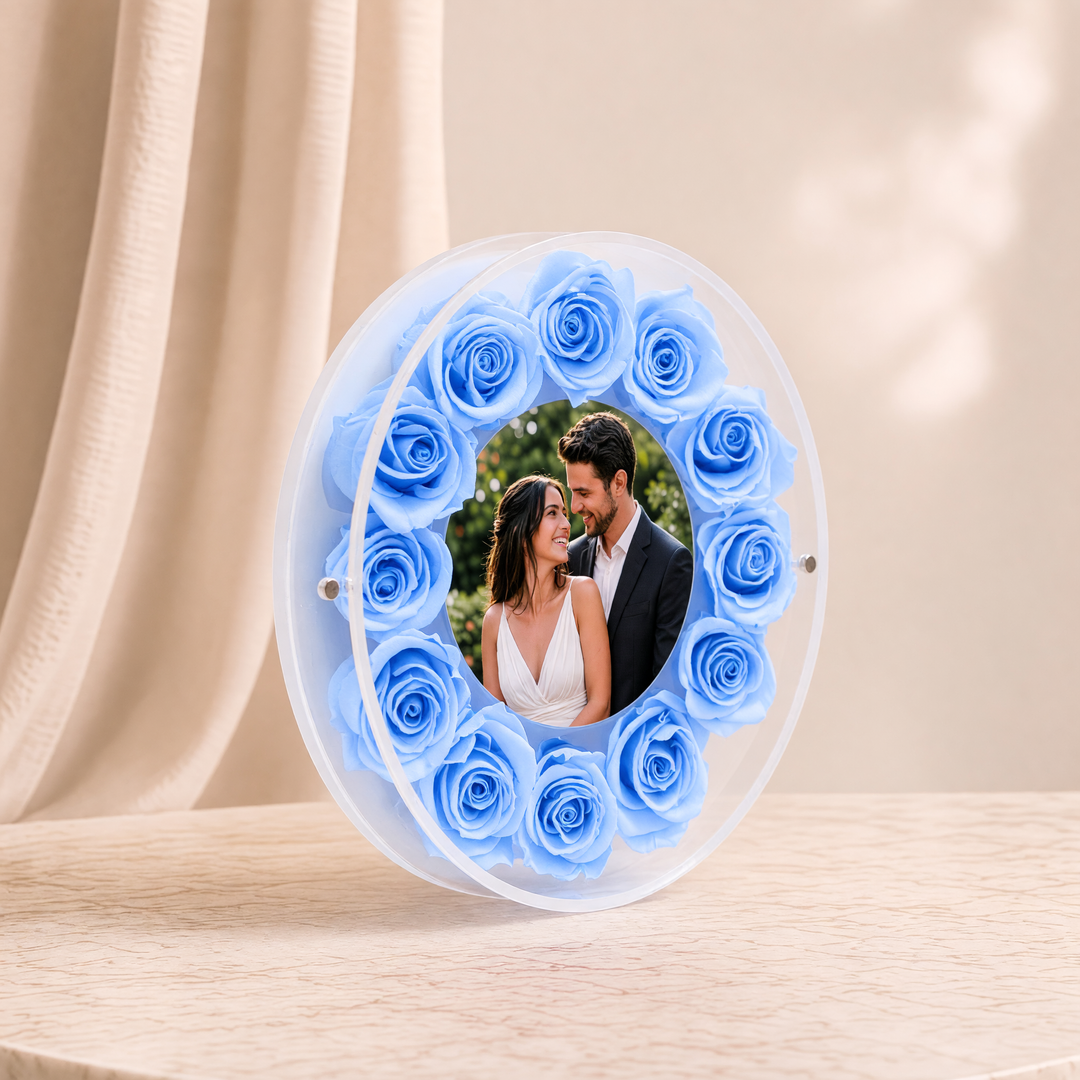 Small 6-inch round acrylic photo frame with light blue preserved roses, angled view