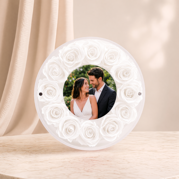 Small 6-inch round acrylic photo frame with white preserved roses, front view