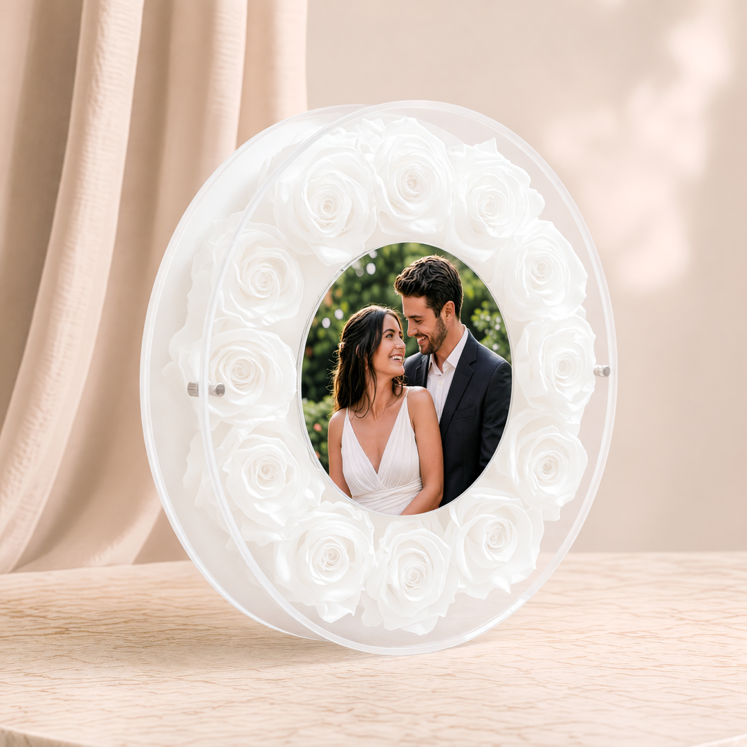 Small 6-inch round acrylic photo frame with white preserved roses, angled view
