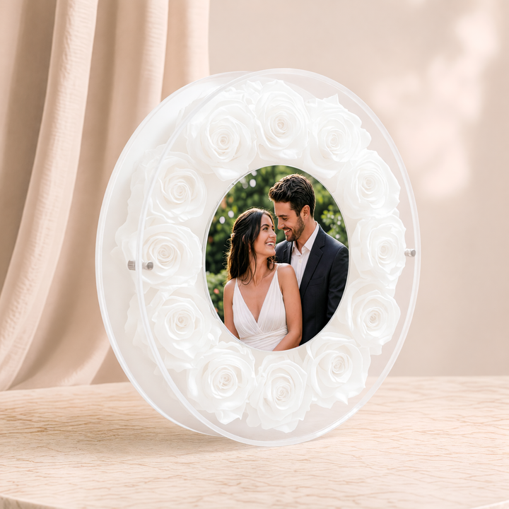 Small 6-inch round acrylic photo frame with white preserved roses, angled view
