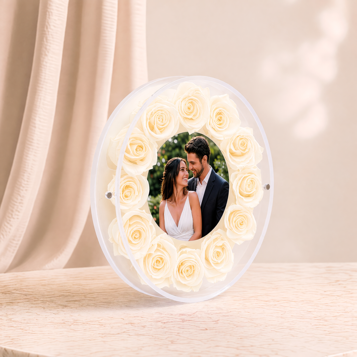 Small 6-inch round acrylic photo frame with cream preserved roses, angled view