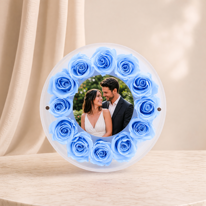 Small 6-inch round acrylic photo frame with light blue preserved roses, front view