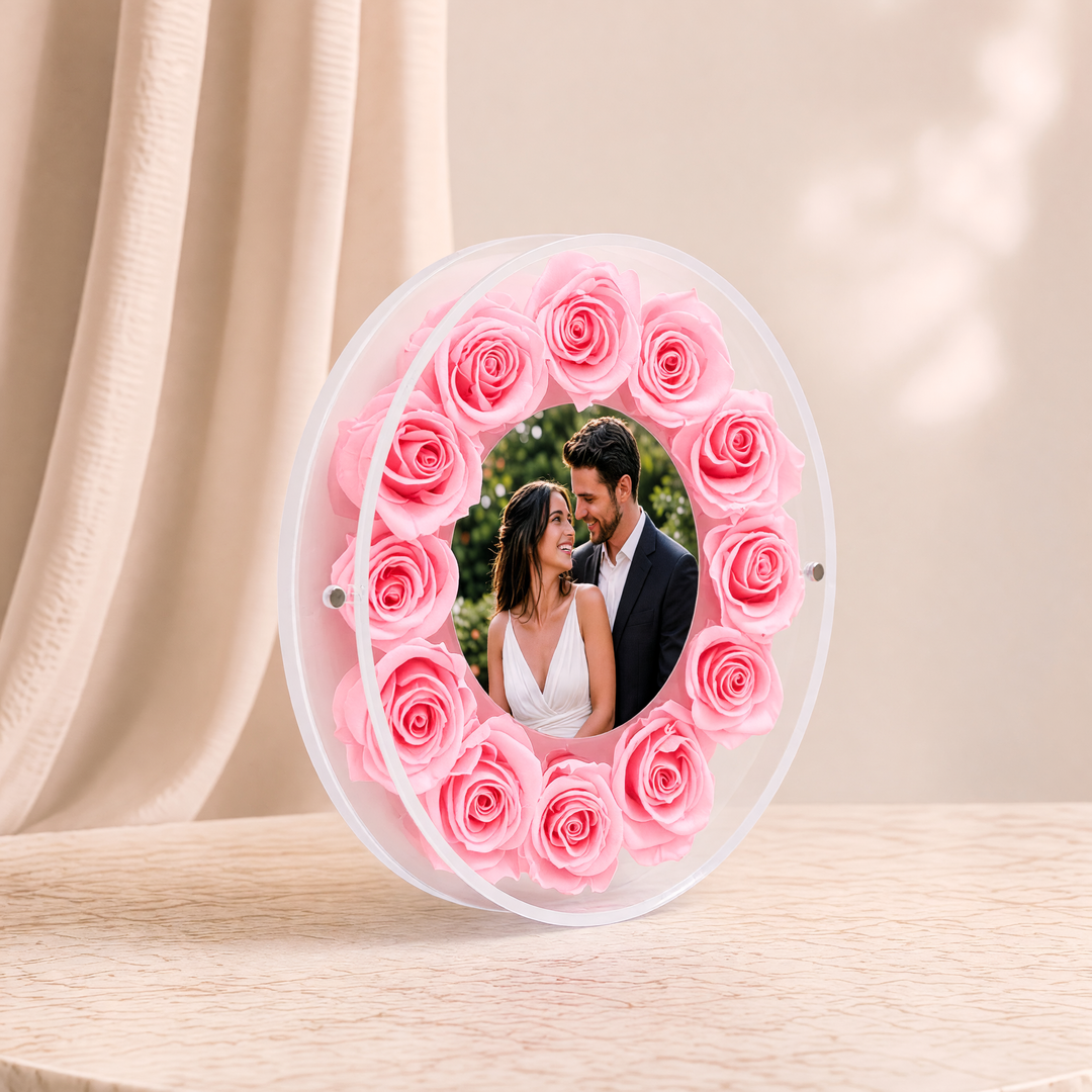 Small 6-inch round acrylic photo frame with pink preserved roses, angled view