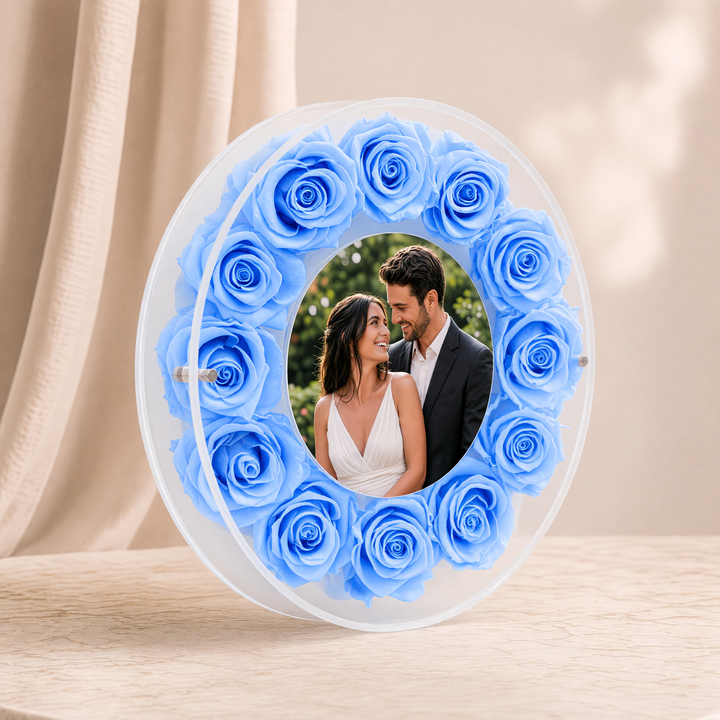 Large 10-inch round acrylic photo frame with light blue preserved roses, angled view