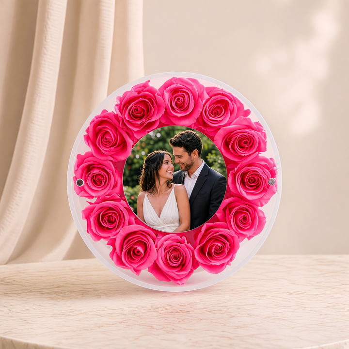 Small 6-inch round acrylic photo frame with fuchsia preserved roses, front view