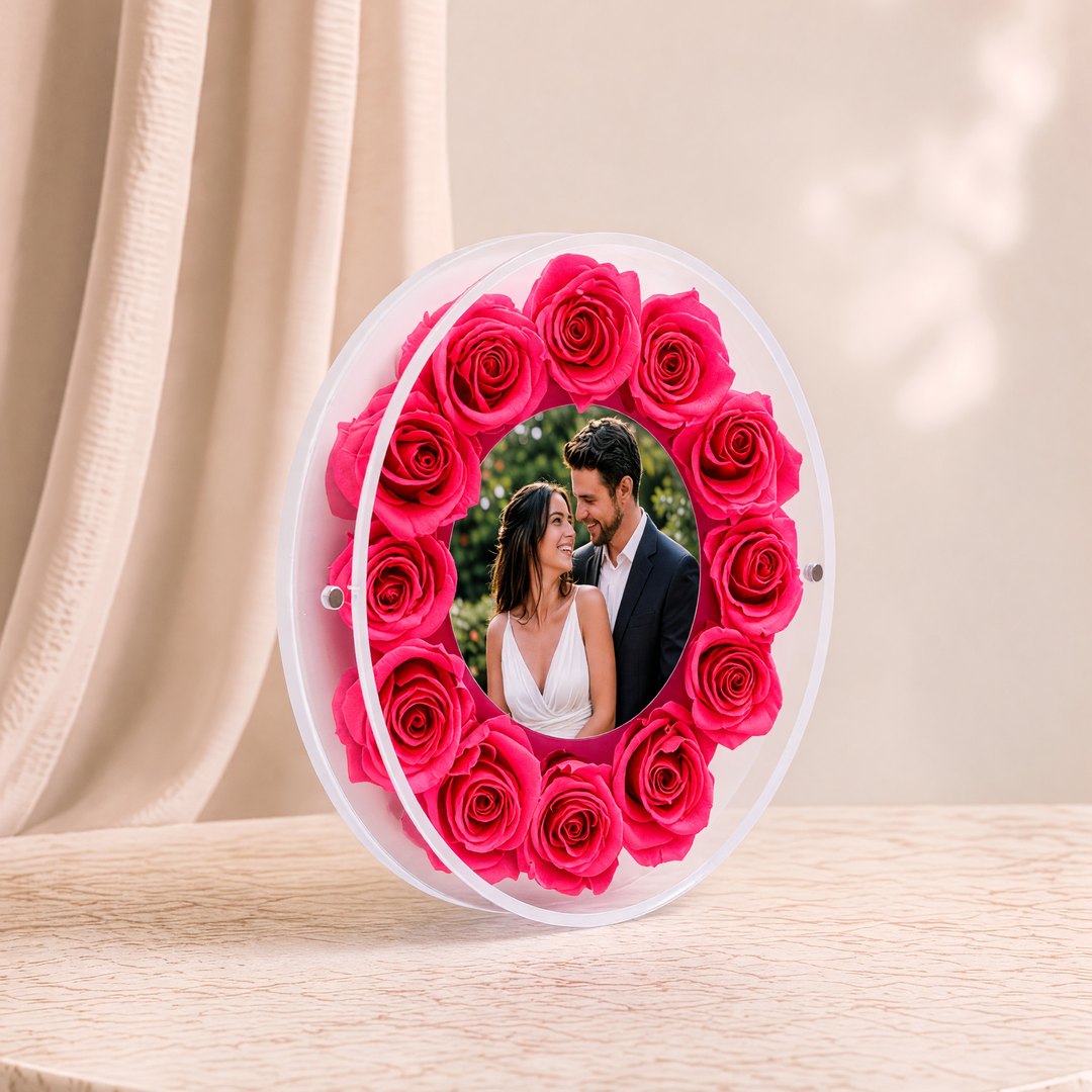 Small 6-inch round acrylic photo frame with fuchsia preserved roses, angled view