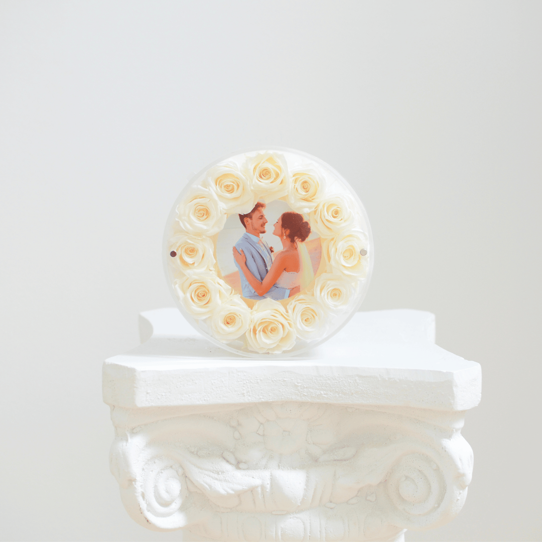 round picture frame with white preserved roses 