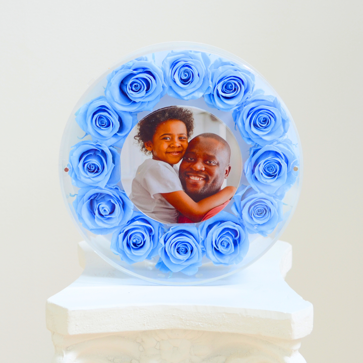 Original photograph of the light blue large Halo preserved rose frame, front view on a white pedestal
