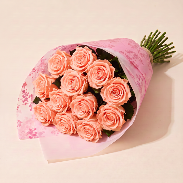 Dozen preserved roses in pink floral wrap - Peach Nectar
